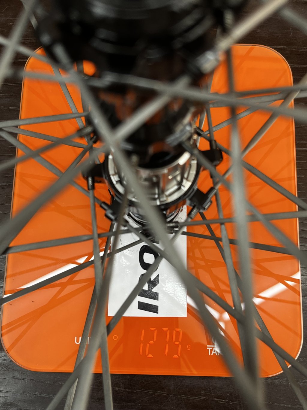 IronDeer G50 SL carbon gravel wheelset on a workshop scale showing 1279 g.